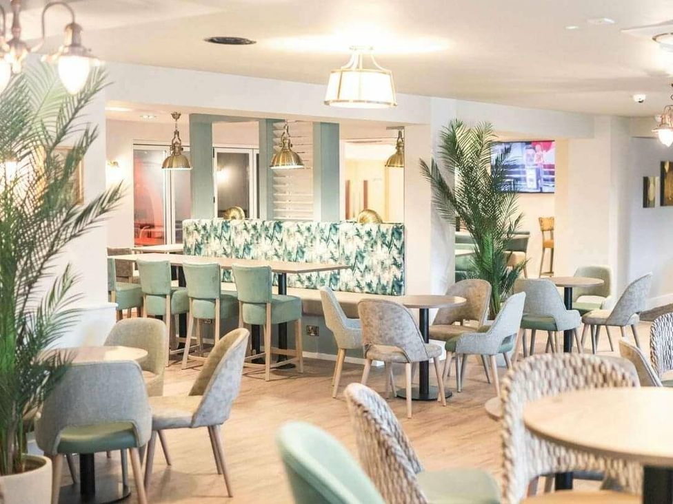 a dining area with chairs and tables at Shorefield Country Park - Holiday Accommodation 3042 in Milford On Sea