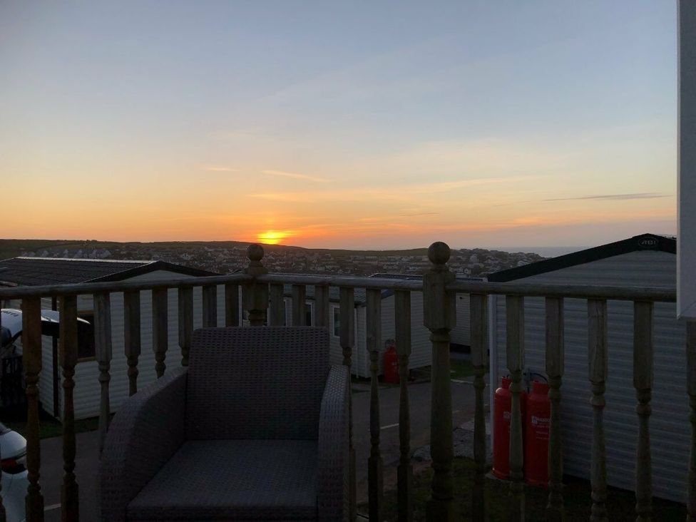 a sunset view from a balcony overlooking holiday caravans at Liskey Hill Caravan Park - Holiday Accommodation 3043 Perranporth
