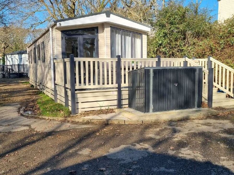 a holiday home unit with a deck and outdoor railing at Shorefield Country Park - Holiday Accommodation 4132 Milford On Sea