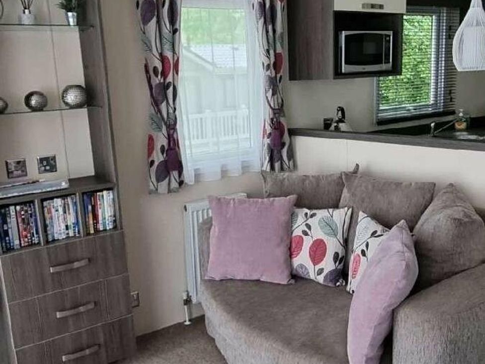 a living room with a sofa and television unit at Shorefield Country Park - Holiday Accommodation 4132, Milford On Sea