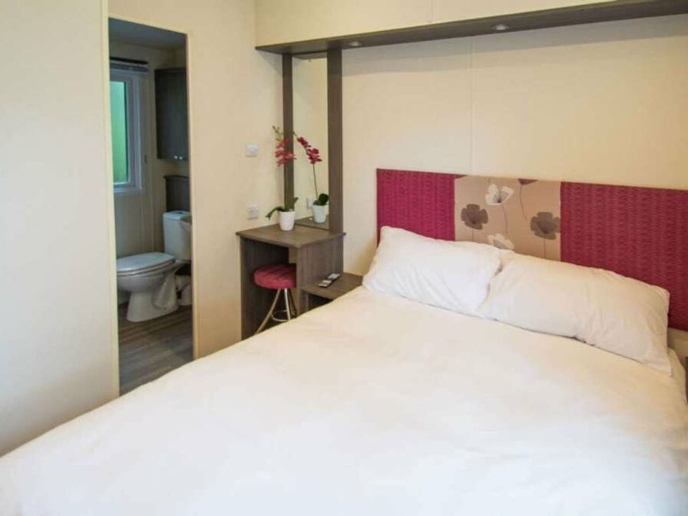 a bedroom with a double bed and a bathroom view at Shorefield Country Park - Holiday Accommodation 4132 in Milford On Sea