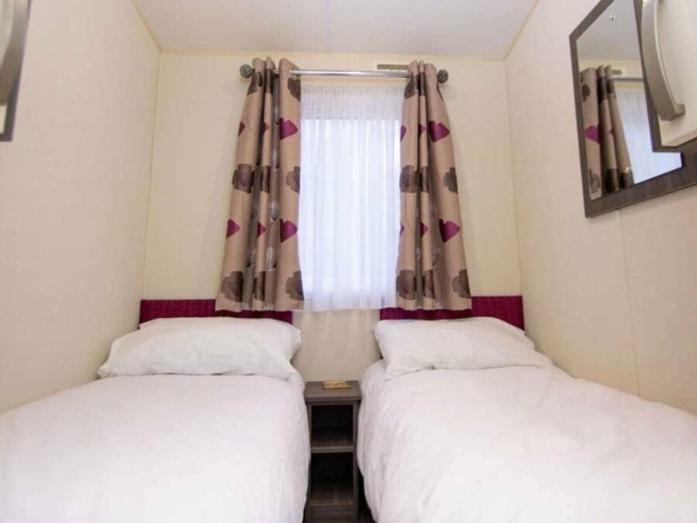 a bedroom with two single beds and a window at Shorefield Country Park - Holiday Accommodation 4132 in Milford On Sea