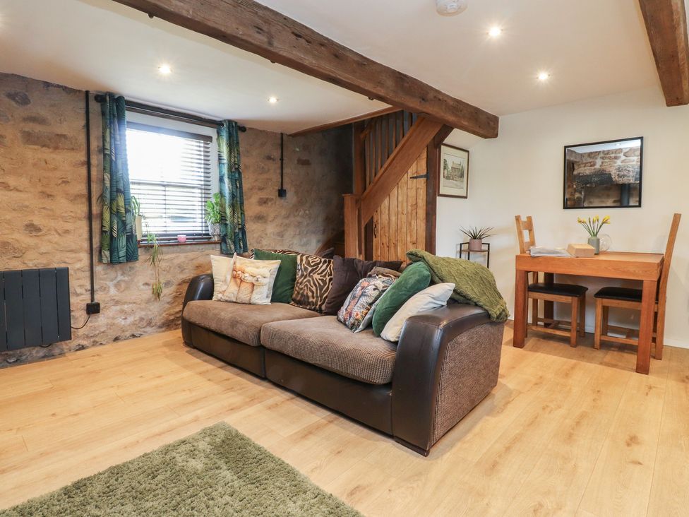 A living room with a sofa and dining table at The Snug in Morecambe