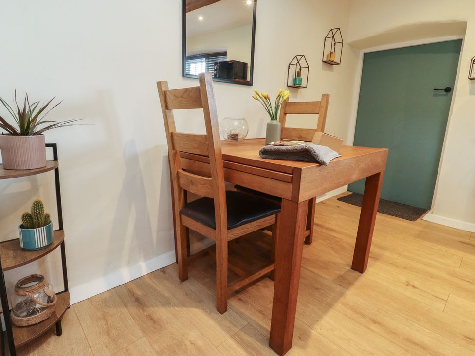 A dining room with a table and chairs at The Snug in Morecambe