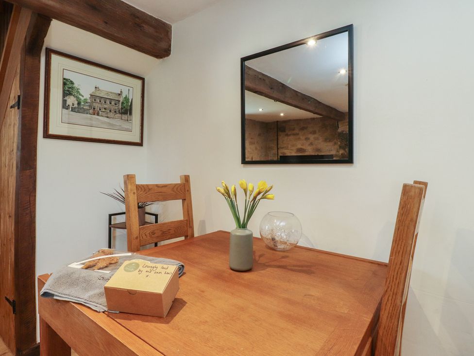 A dining room with a table and chairs at The Snug in Morecambe