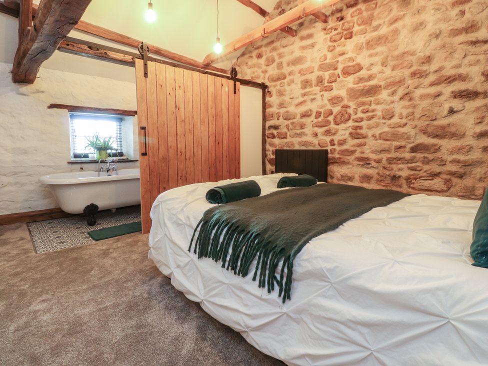 A bedroom with a bed and a bath tub at The Snug in Morecambe