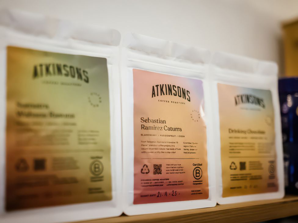 Coffee bags from Atkinsons Coffee Roasters stacked on a shelf