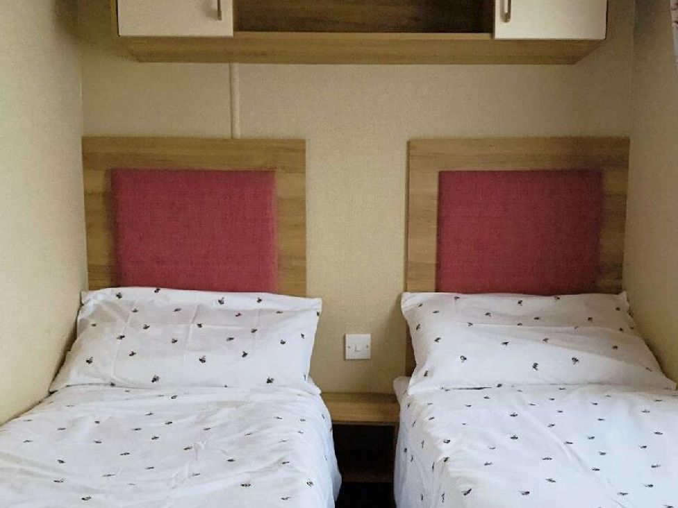 a bedroom with two single beds and a shelf above at St Andrews Holiday Park - Holiday Accommodation 609 in St. Andrews