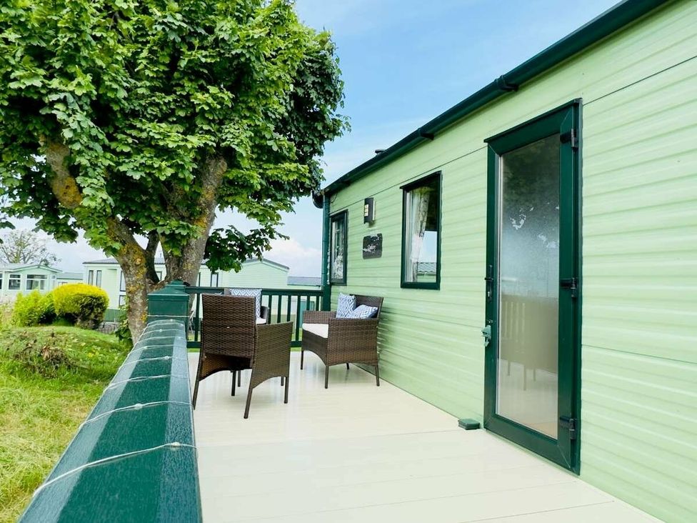 a green exterior of a holiday caravan with a small deck and seating area at St Andrews Holiday Park - Holiday Accommodation 609 St. Andrews