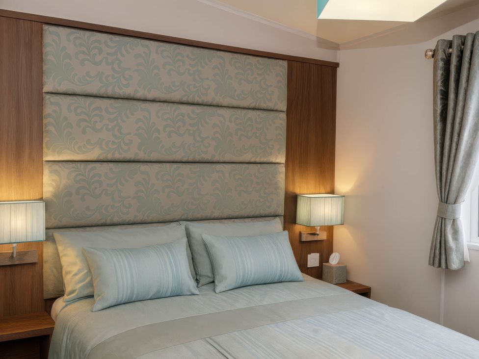 A bedroom with a bed and bedside tables at Hopton Holiday Village - Holiday Accommodation 632 Great Yarmouth