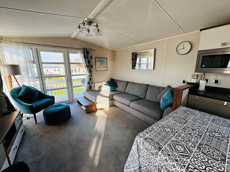 A living room with a sofa and armchair at Hopton Holiday Village - Holiday Accommodation 632 Great Yarmouth