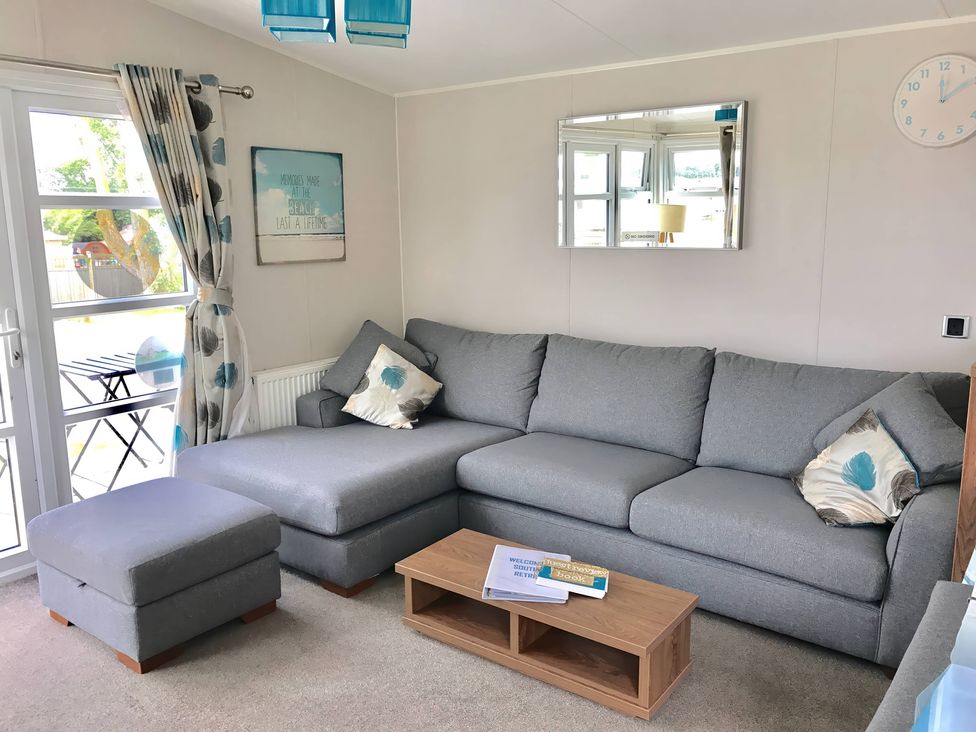 A living room with a sofa and coffee table at Hopton Holiday Village - Holiday Accommodation 632, Great Yarmouth