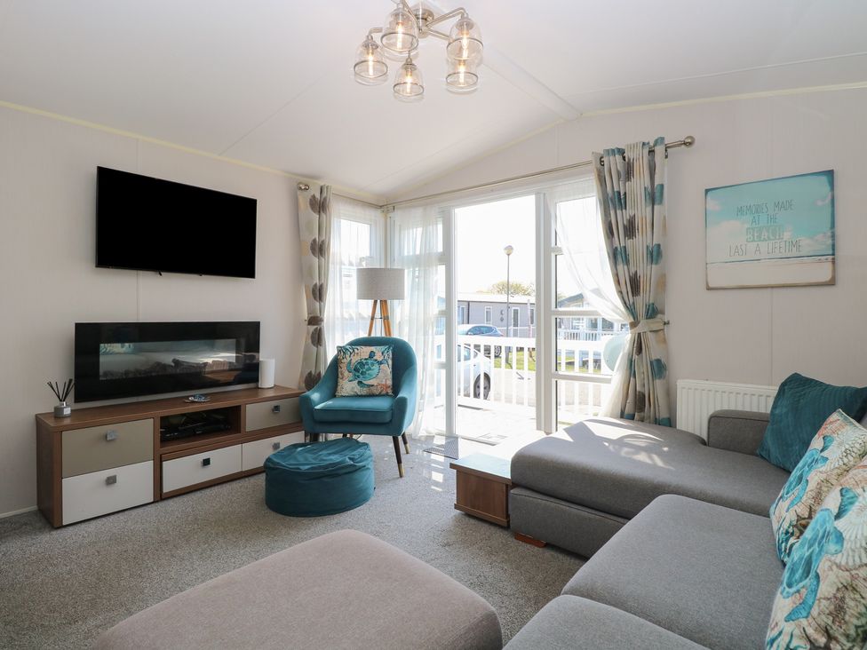 A living room with a sofa and television at Hopton Holiday Village - Holiday Accommodation 632 Hopton-On-Sea