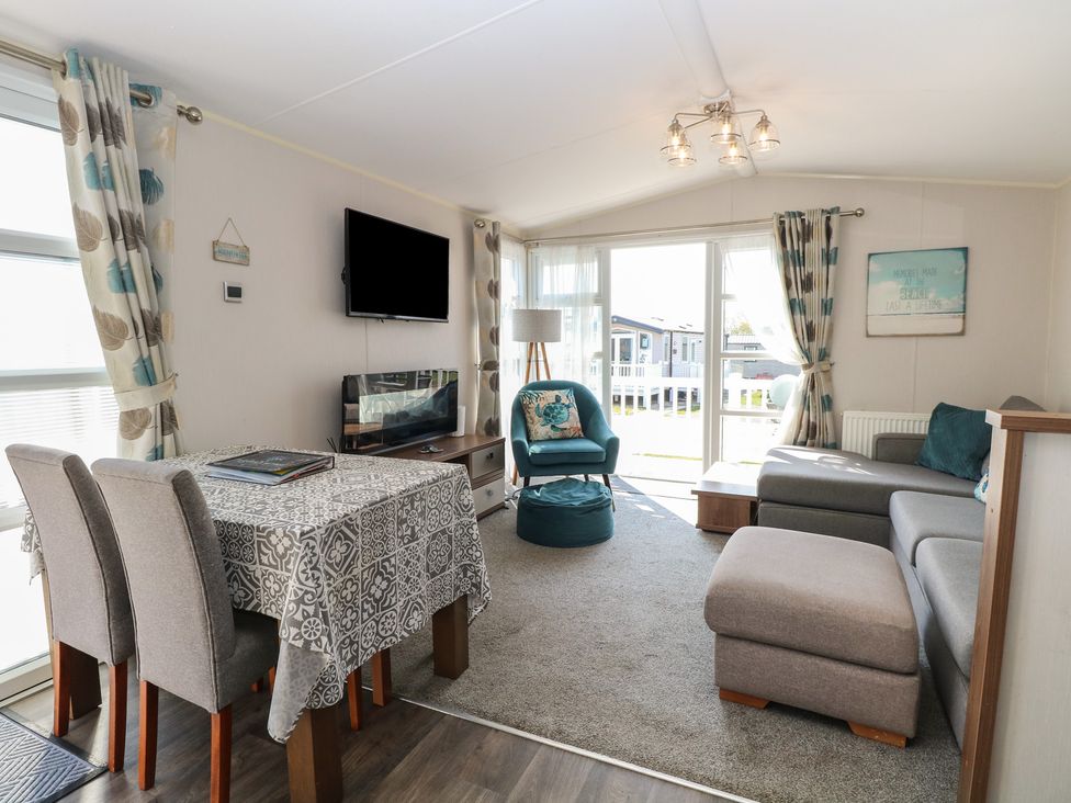 A living room with a table and chairs at Hopton Holiday Village - Holiday Accommodation 632 Hopton-On-Sea