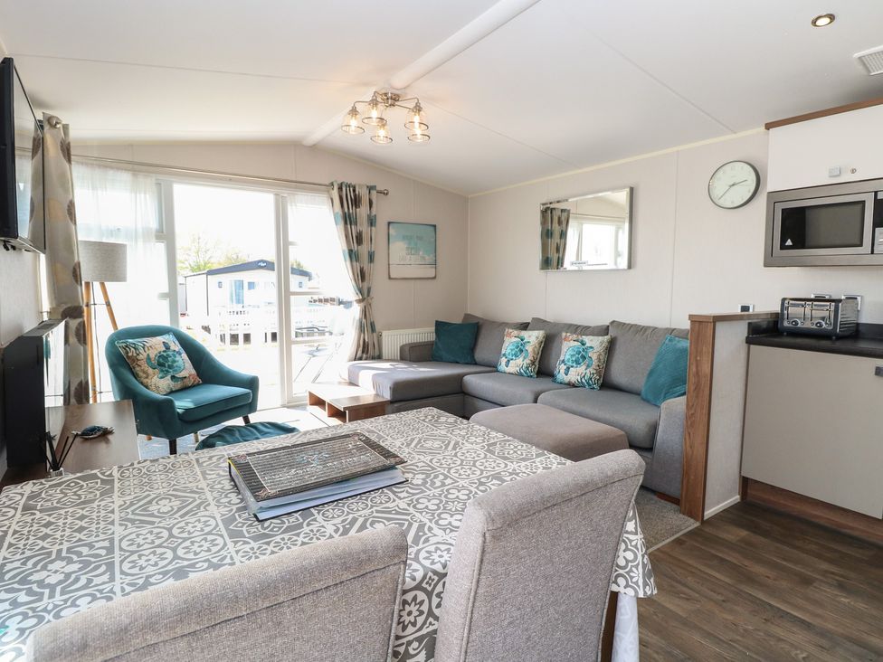 A living room with a sofa, table and chairs at Hopton Holiday Village - Holiday Accommodation 632 Hopton-On-Sea