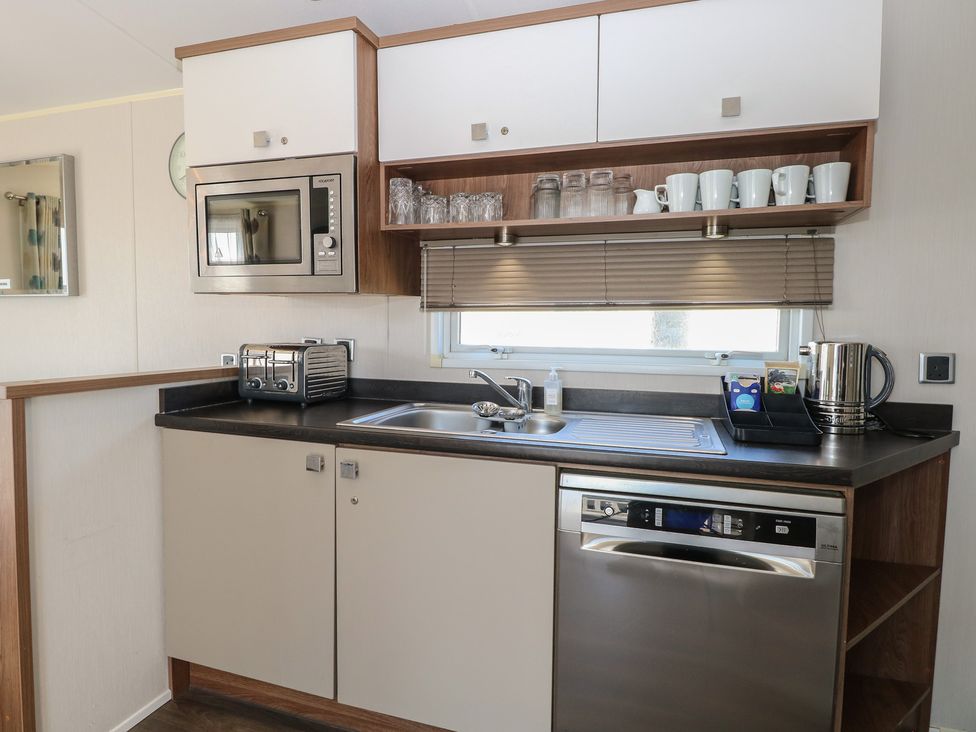 A kitchen with modern appliances at Hopton Holiday Village - Holiday Accommodation 632, Hopton-On-Sea