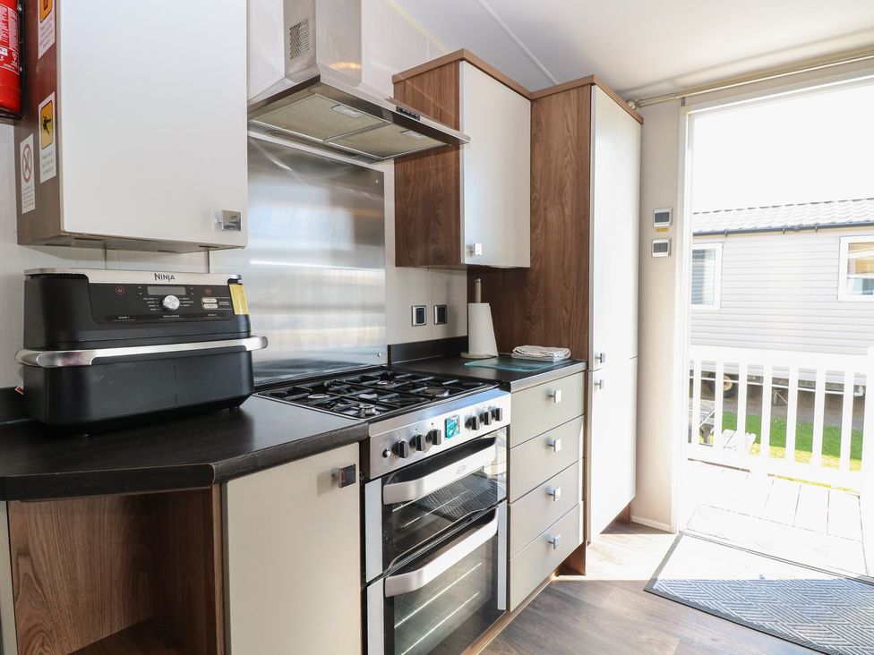 A kitchen with an oven and stove at Hopton Holiday Village - Holiday Accommodation 632 Hopton-On-Sea