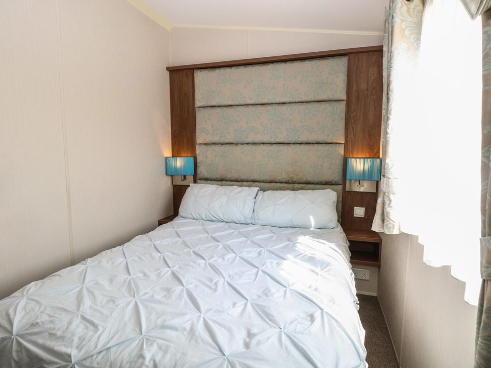 A bedroom with a bed and bedside lamps at Hopton Holiday Village - Holiday Accommodation 632 Hopton-On-Sea
