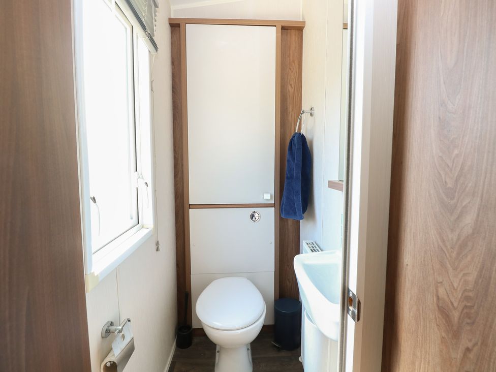 A bathroom with a toilet and sink at Hopton Holiday Village - Holiday Accommodation 632 in Hopton-On-Sea