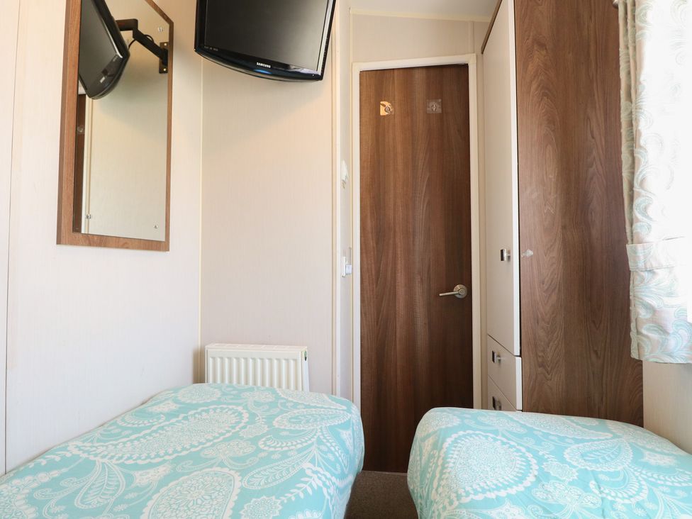 A bedroom with two beds and a television at Hopton Holiday Village - Holiday Accommodation 632 Hopton-On-Sea