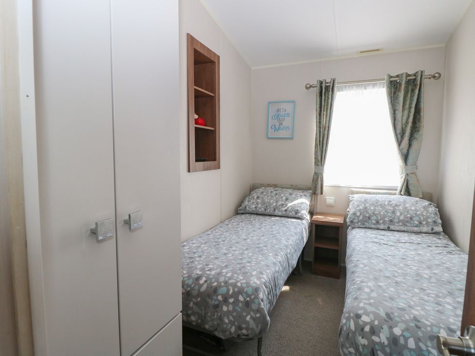 A bedroom with twin beds and a wardrobe at Hopton Holiday Village - Holiday Accommodation 632 Hopton-On-Sea