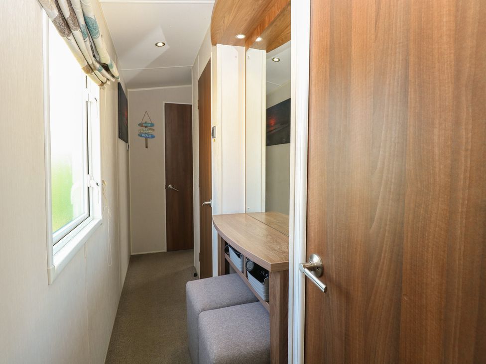 A hallway with a mirror and seating area at Hopton Holiday Village - Holiday Accommodation 632 Hopton-On-Sea