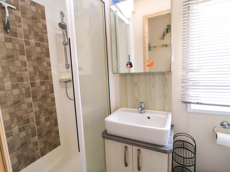 A bathroom with a shower and sink at Beachcombers in Wareham