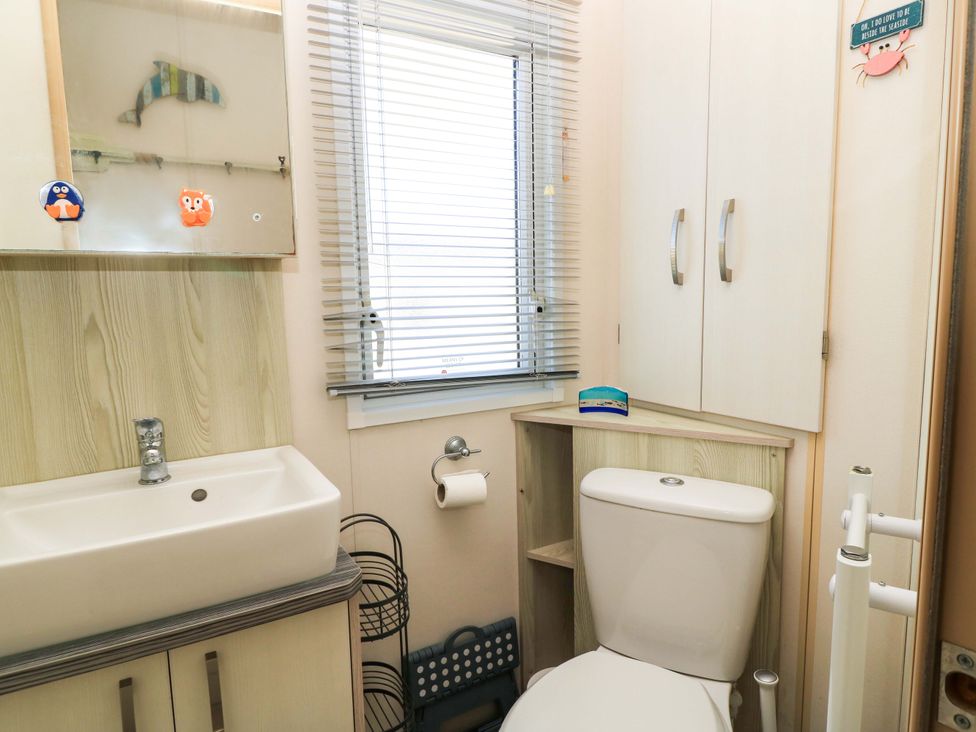 A bathroom with a sink and toilet at Beachcombers in Wareham