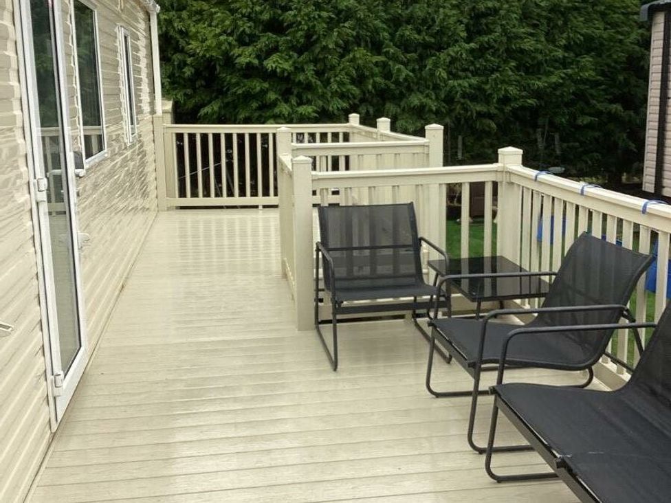 a deck with chairs and a table at Southview Holiday Park - Holiday Accommodation 7251 in Skegness
