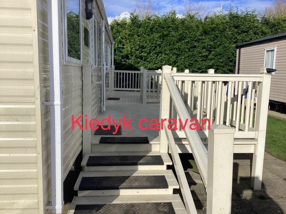 a caravan entrance with steps and a deck area at Kiedyk caravan in Skegness