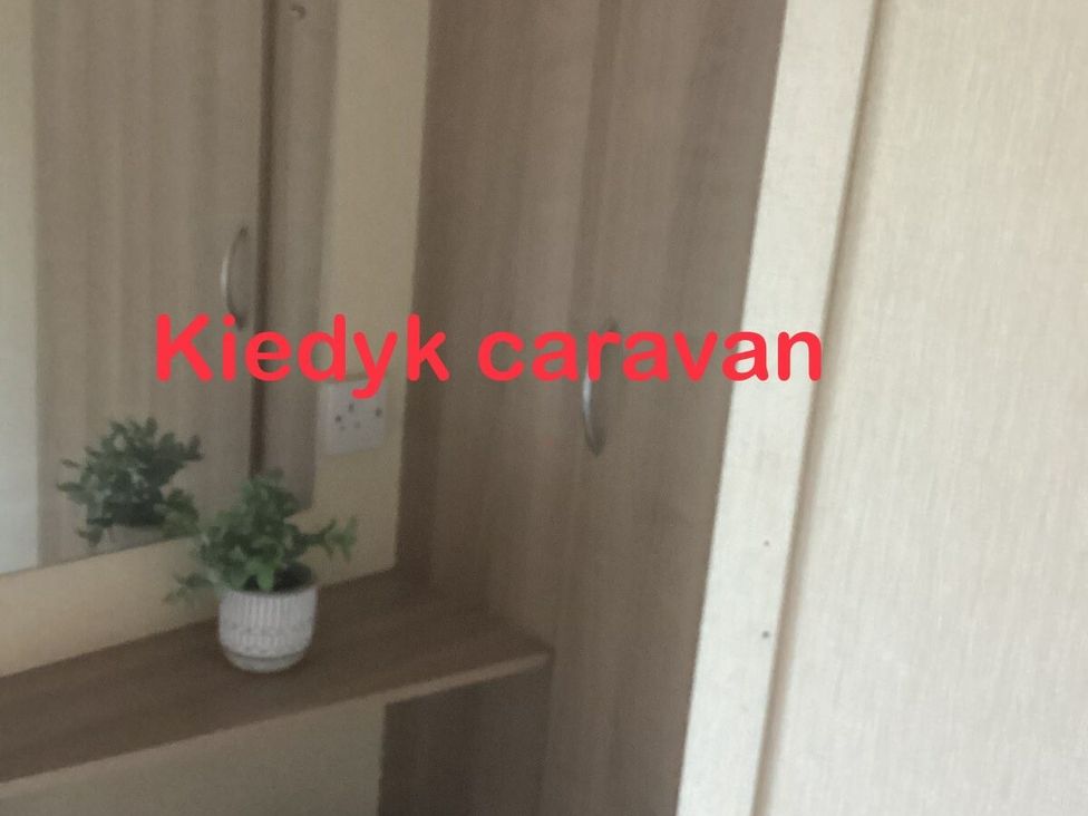 a dressing area with a mirror and a small plant at Southview Holiday Park - Holiday Accommodation 7251, Skegness