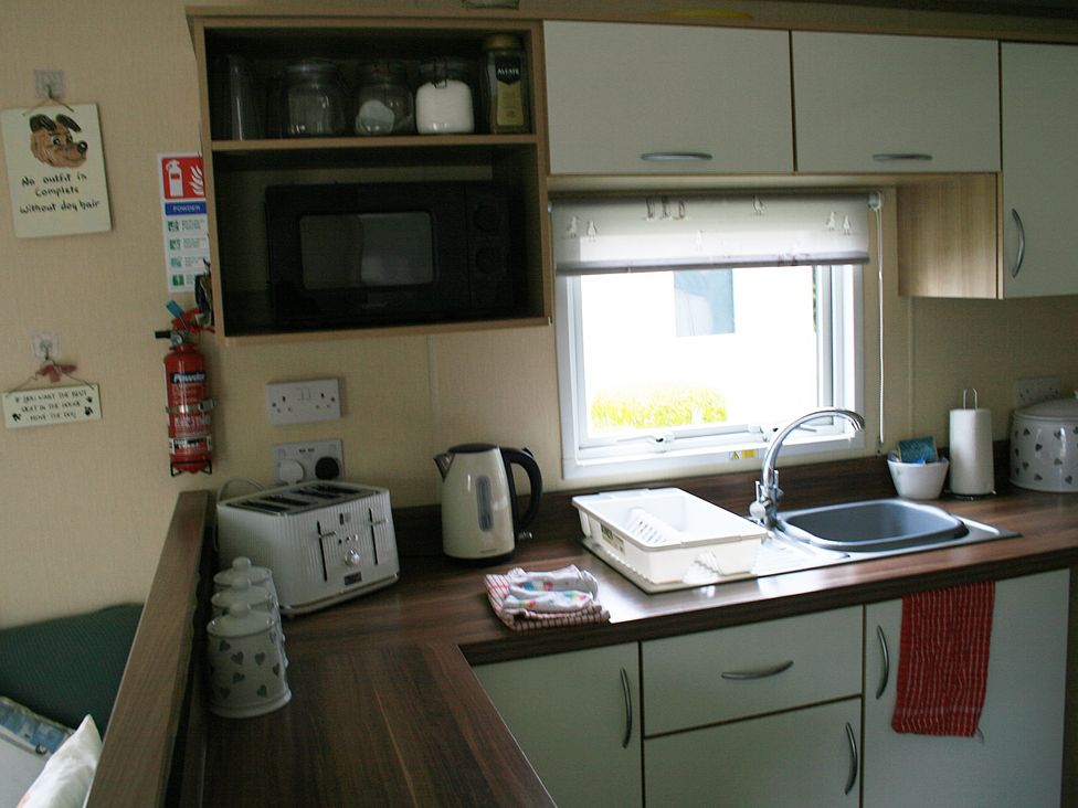 A kitchen with a sink and appliances at Southview Holiday Park 7251 Skegness