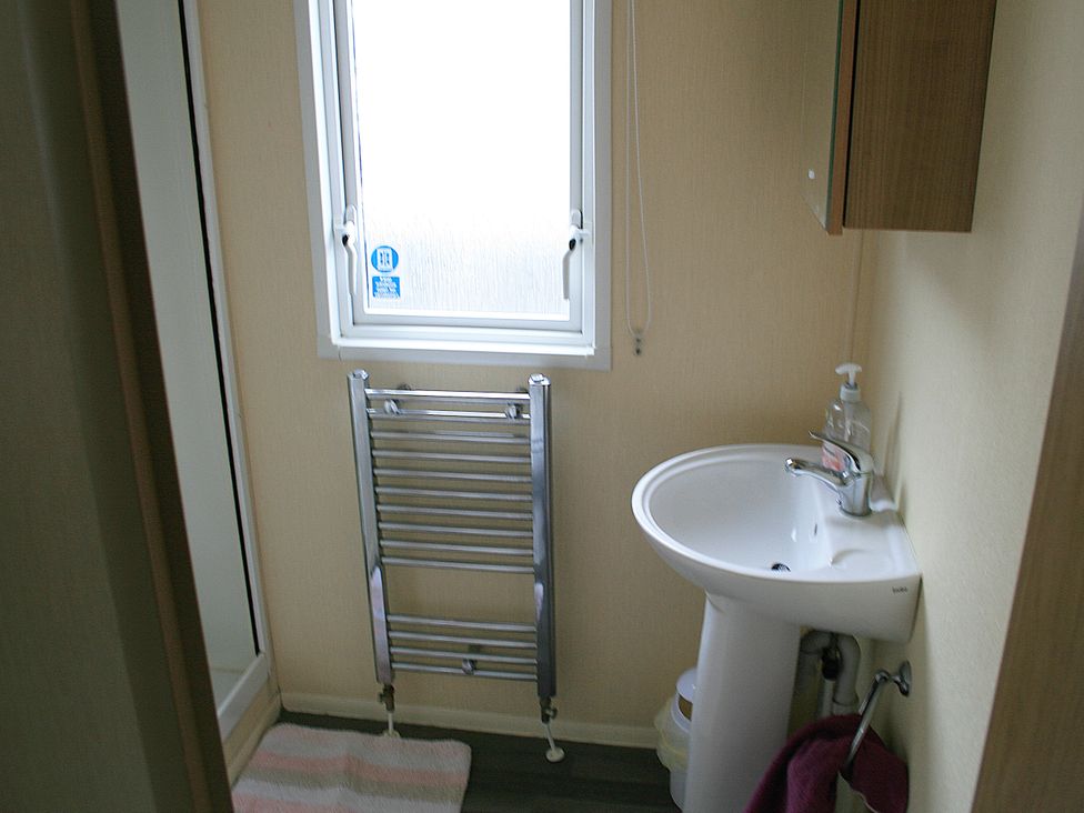 A bathroom with a sink and towel rail at Southview Holiday Park 7251 Skegness