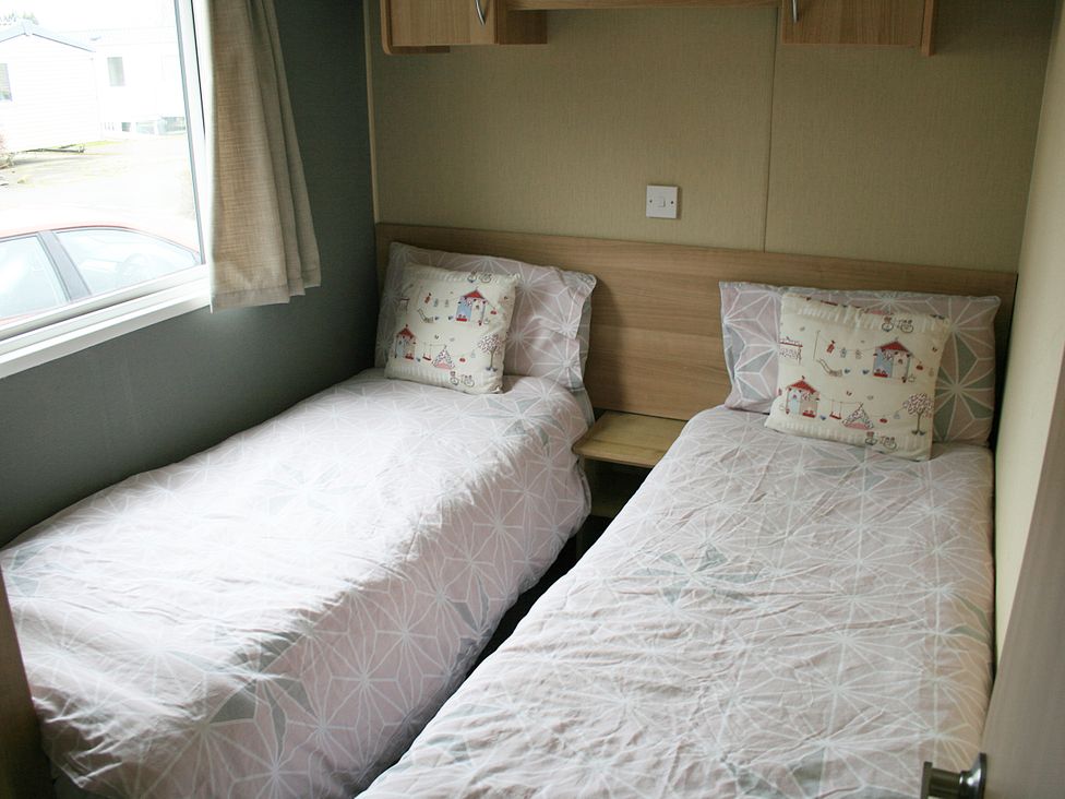 A bedroom with two single beds at Southview Holiday Park 7251 Skegness