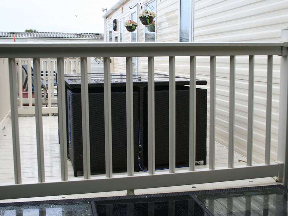 An outdoor area with a table and railing at Southview Holiday Park 7251 Skegness