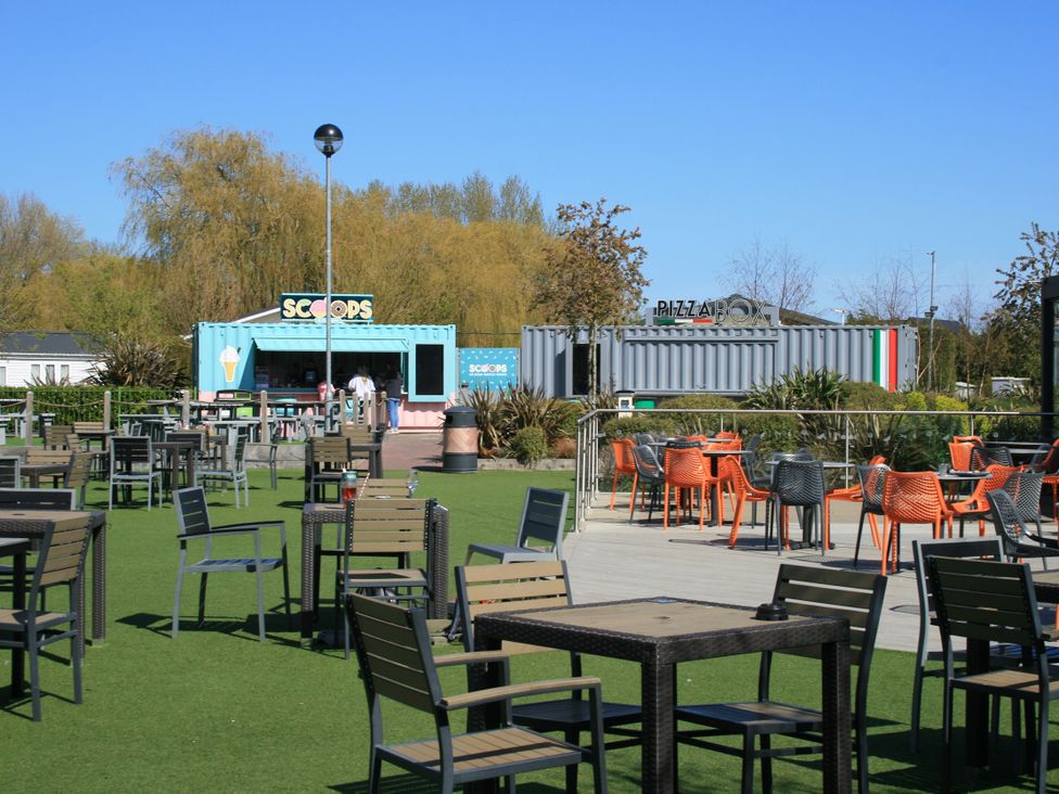 An outdoor area with tables and food stands at Southview Holiday Park 7251 Skegness