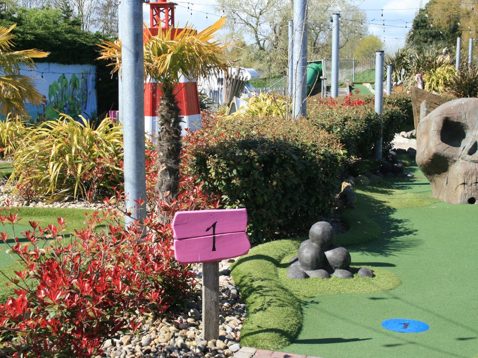 A mini golf course with a sign and landscaping at Southview Holiday Park 7251 Skegness