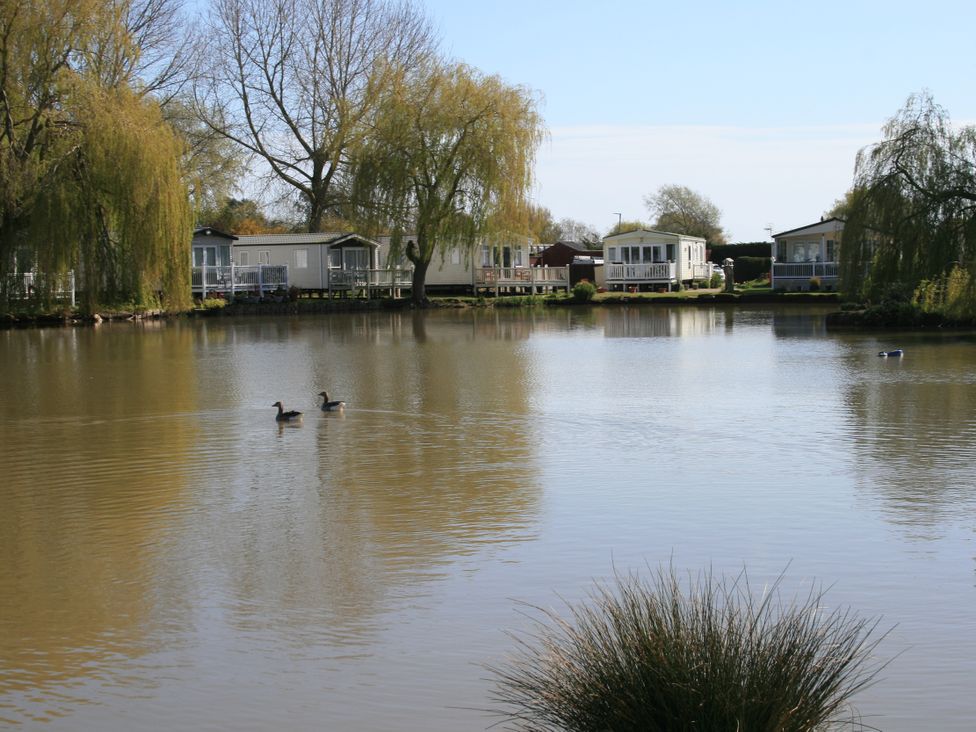 A lake with ducks and caravans at Southview Holiday Park 7251 Skegness