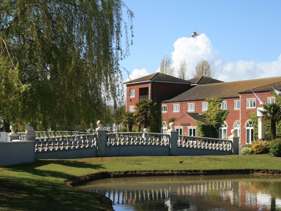 A building next to a body of water with a bridge at Southview Holiday Park 7251 Skegness