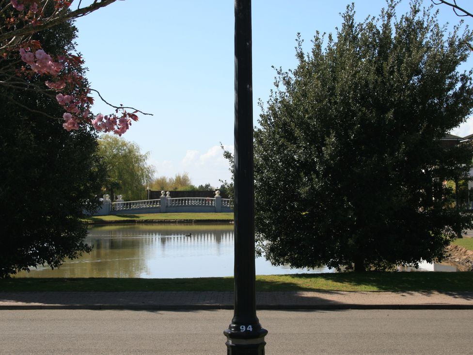 A view of a pond and bridge with trees at Southview Holiday Park 7251 Skegness