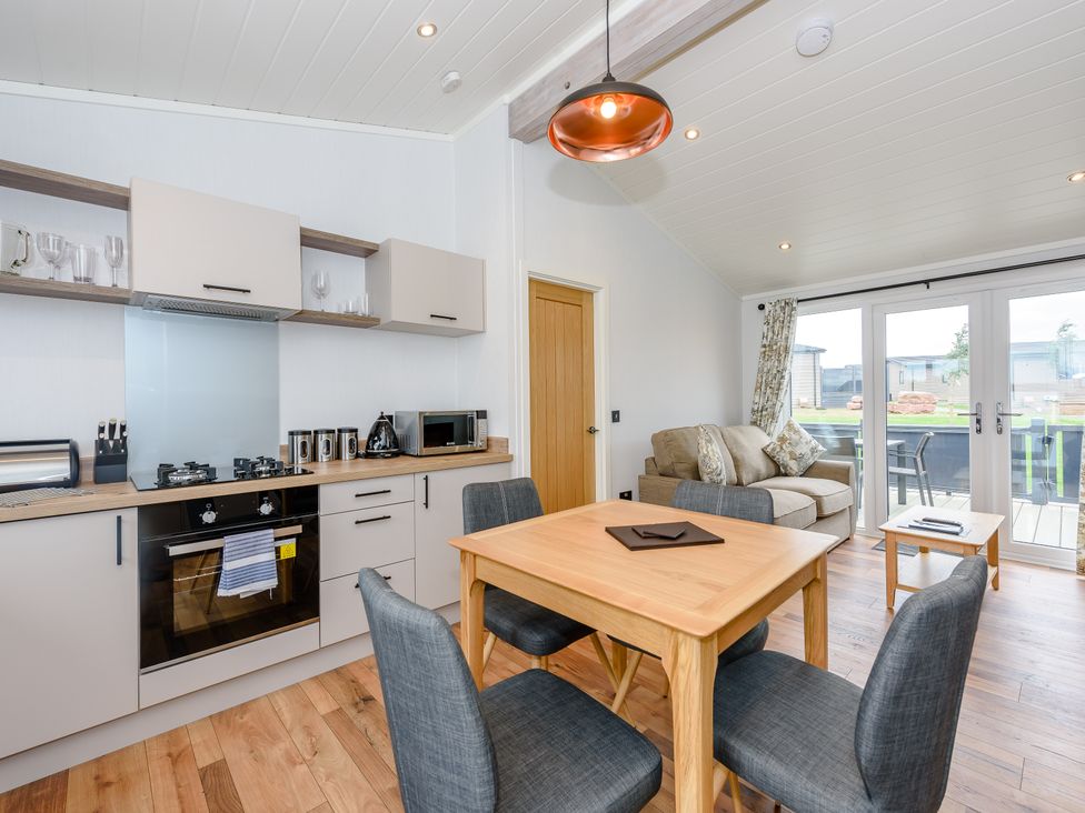 A kitchen with a dining table and chairs at Coniston in Penrith