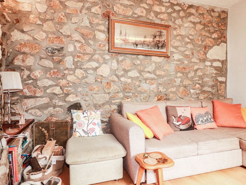 A living room with a stone wall and a sofa at Harford
