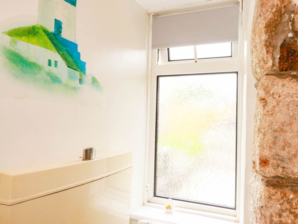 A bathroom featuring a toilet and a decorative wall at Harford