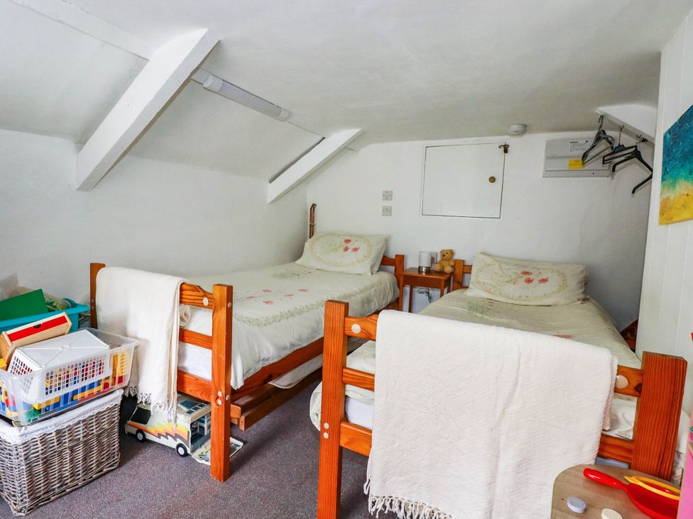 A bedroom with two beds and storage bins at Harford