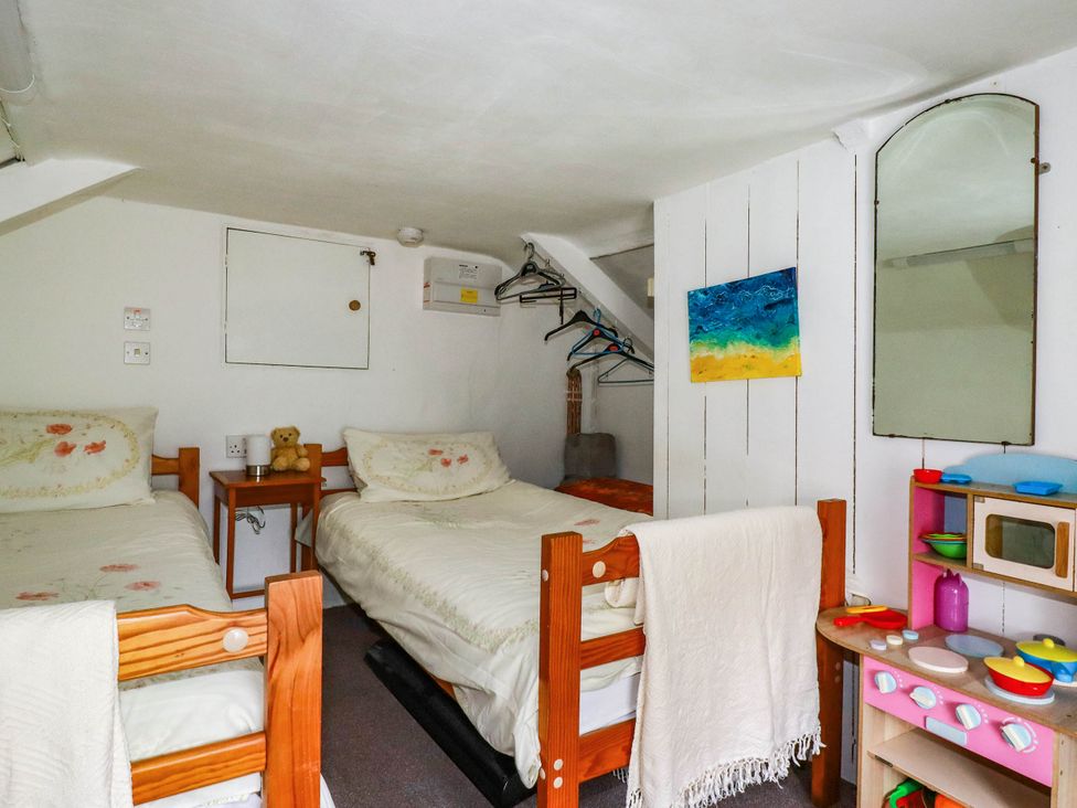 A bedroom with two beds and a toy kitchen set at Harford