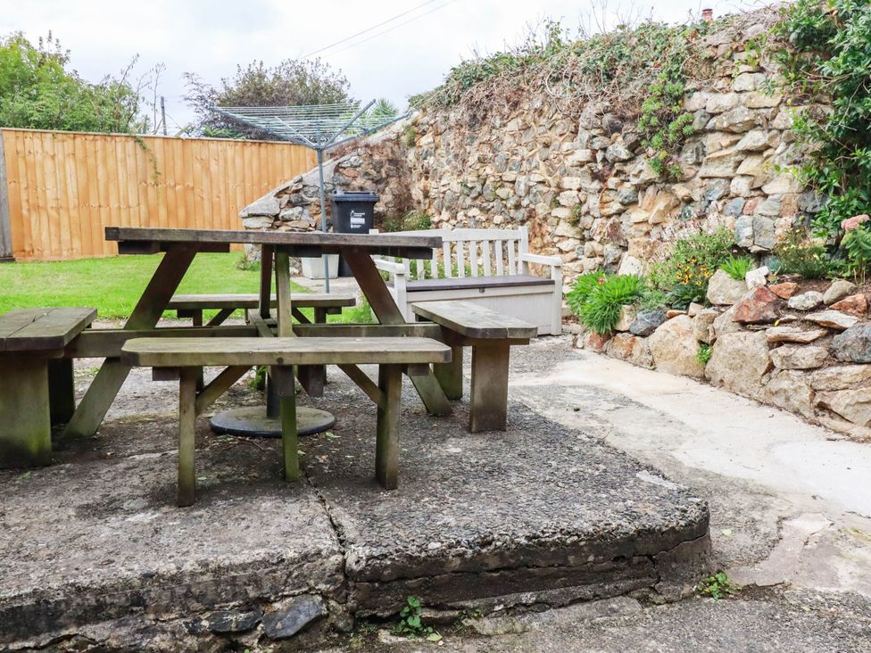 A picnic table with benches in a garden at Harford