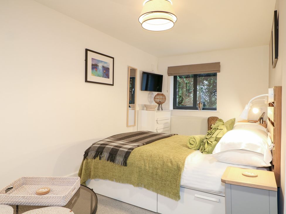 A bedroom with a bed and chest of drawers at The Bullpen in West Tytherley