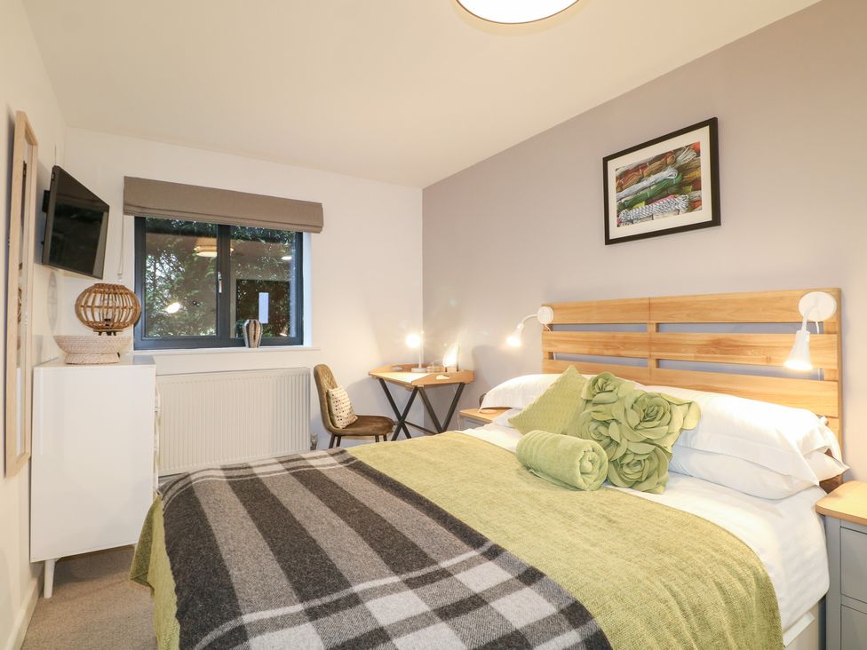 A bedroom with a bed and desk at The Bullpen in West Tytherley