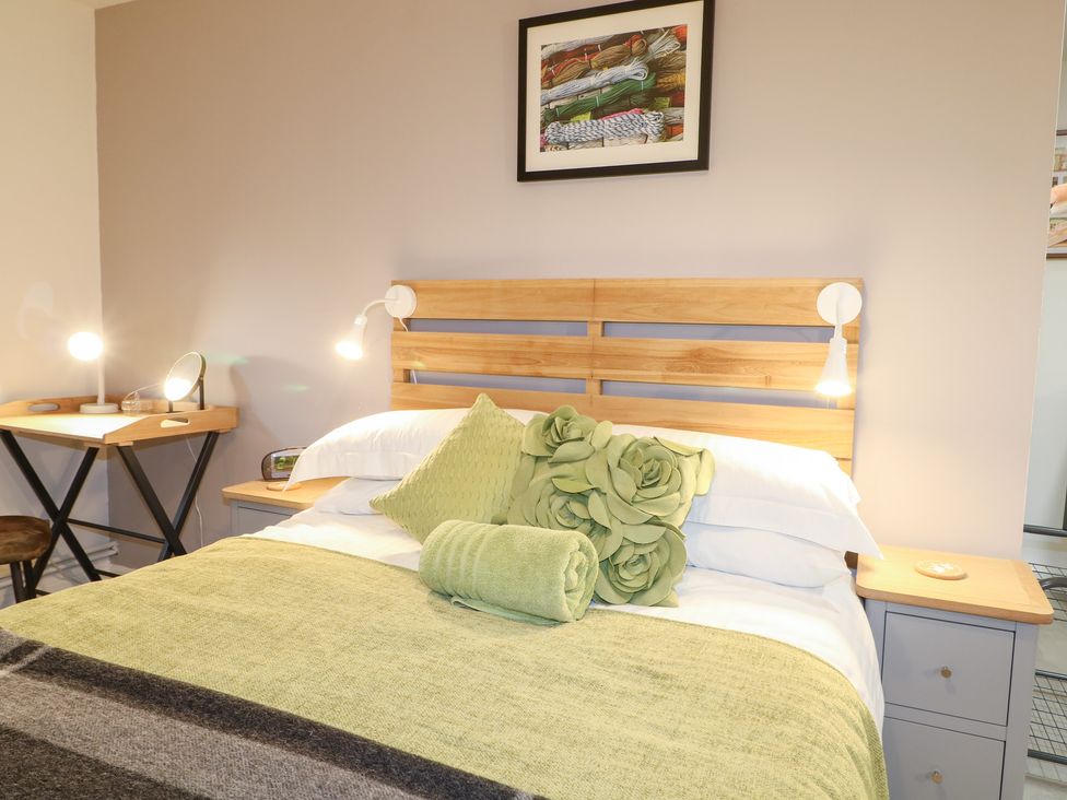 A bedroom with a bed and bedside lamps at The Bullpen in West Tytherley