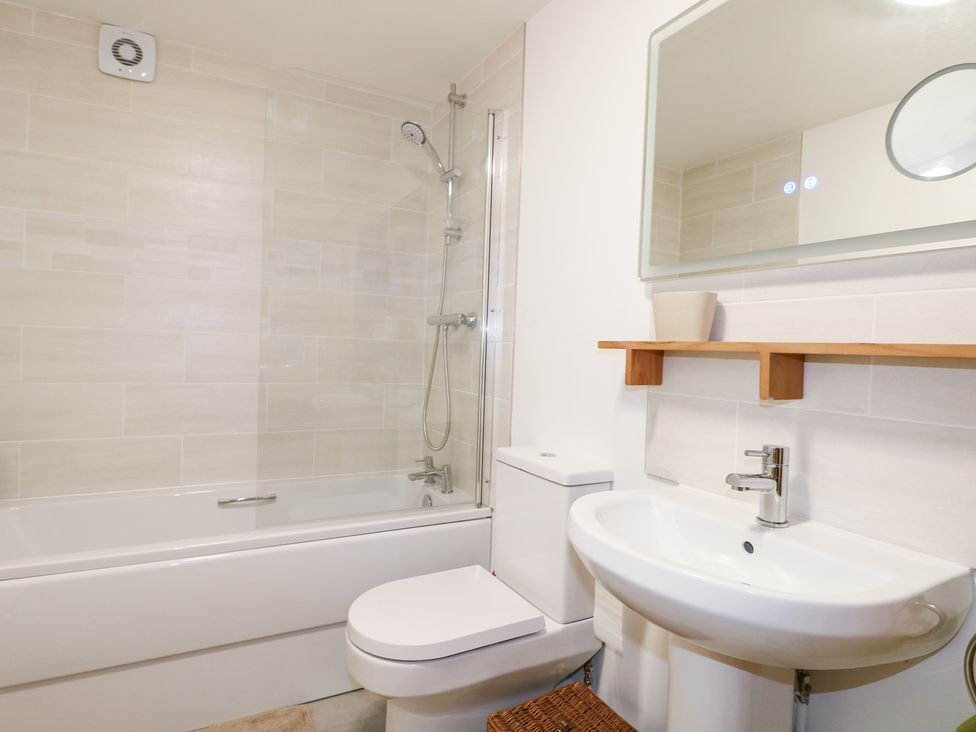 A bathroom with a bathtub, toilet, sink, and shower at The Bullpen in West Tytherley